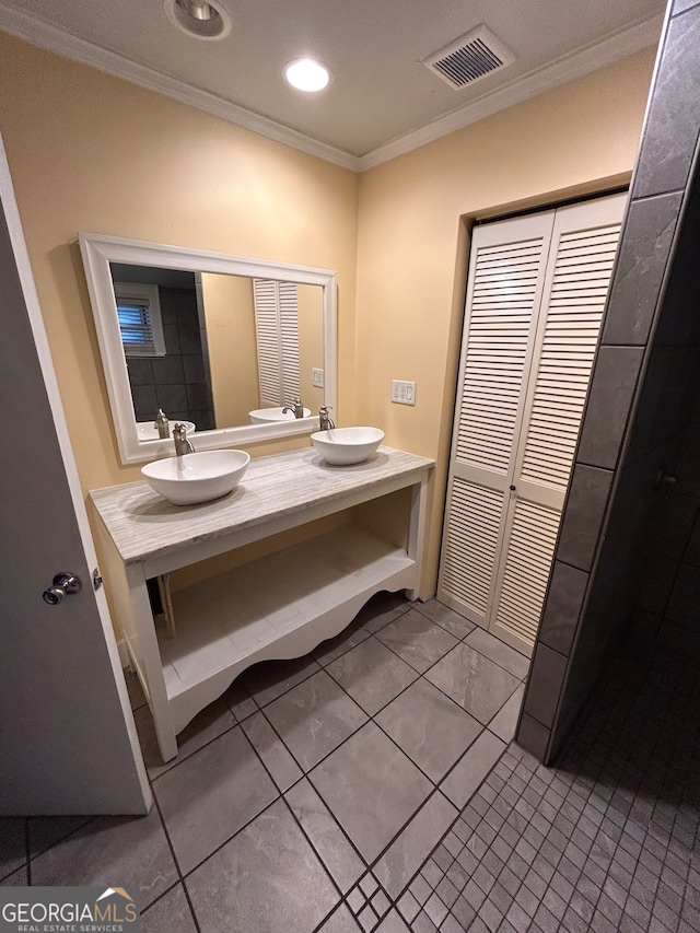 bathroom featuring vanity, ornamental molding, and tile patterned flooring