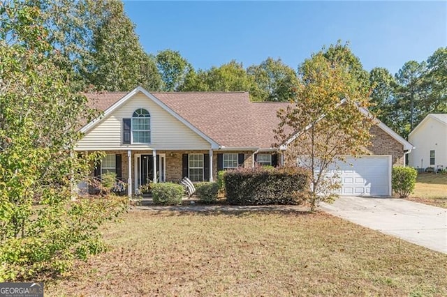 view of front of property featuring covered porch, a garage, and a front lawn