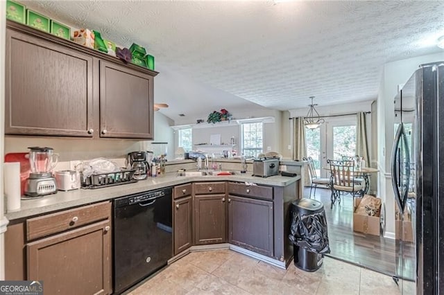 kitchen featuring kitchen peninsula, a textured ceiling, black appliances, french doors, and sink