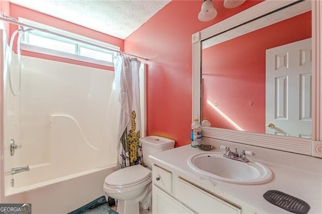 full bathroom featuring vanity, a textured ceiling, toilet, and shower / tub combo