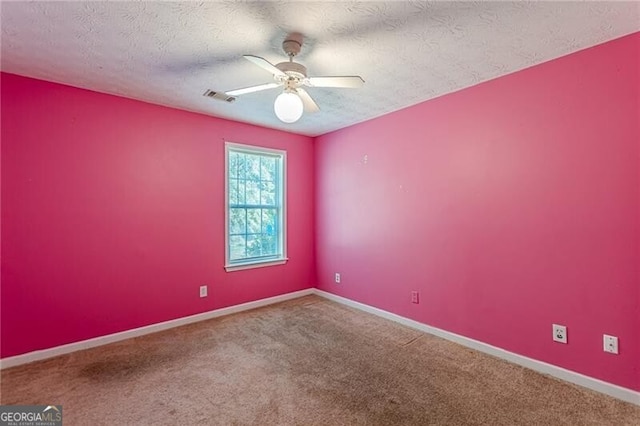 empty room with carpet, a textured ceiling, and ceiling fan