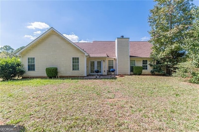 back of property featuring a patio and a lawn