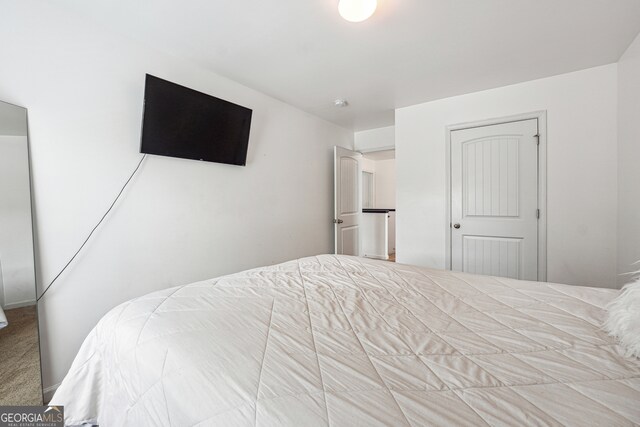 carpeted bedroom with a closet