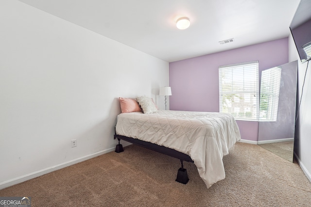 bedroom with light carpet