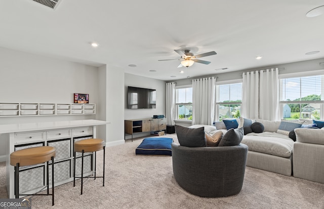 carpeted living room with plenty of natural light and ceiling fan