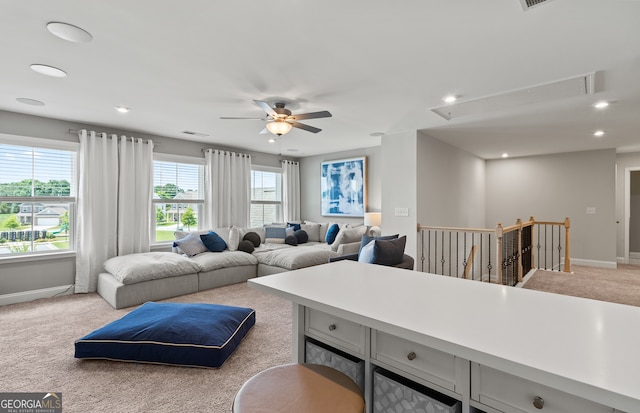 carpeted living room featuring ceiling fan and plenty of natural light