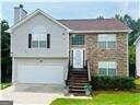 split foyer home featuring driveway, a garage, and a chimney