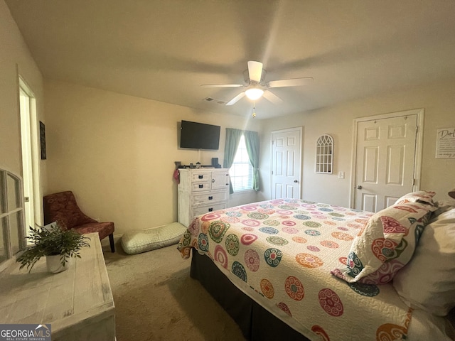 bedroom featuring ceiling fan and carpet