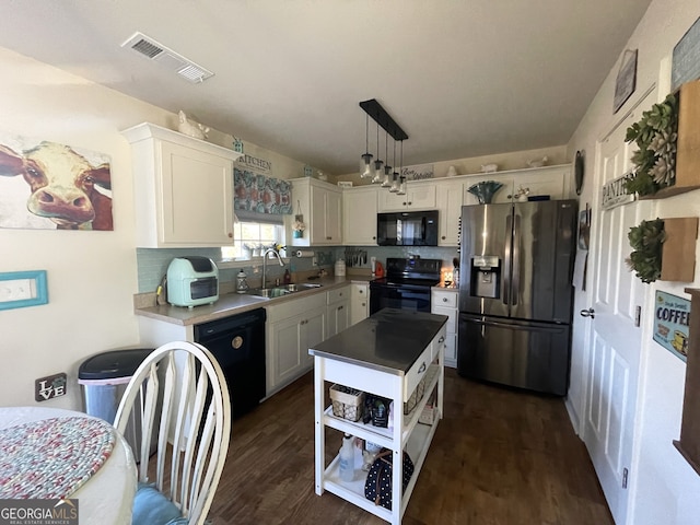 kitchen with white cabinets, black appliances, sink, and hanging light fixtures