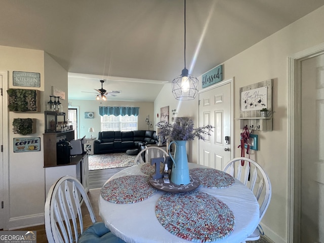 dining area with lofted ceiling, hardwood / wood-style floors, and ceiling fan