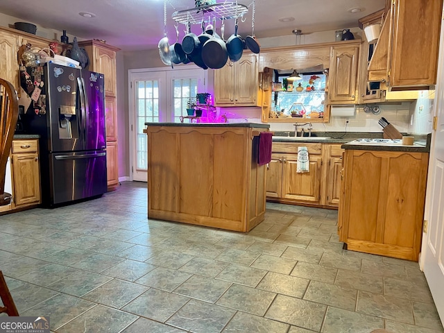 kitchen featuring french doors, stainless steel fridge, sink, and decorative backsplash