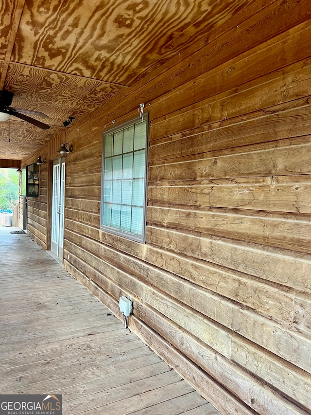 interior space with ceiling fan