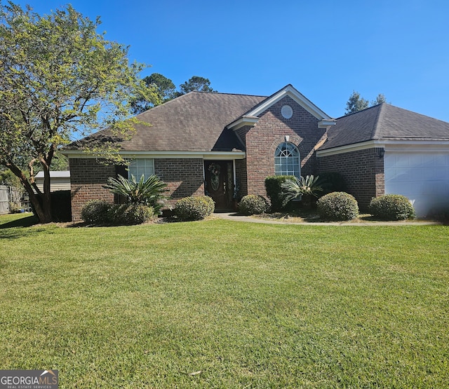 view of front facade with a front yard and a garage