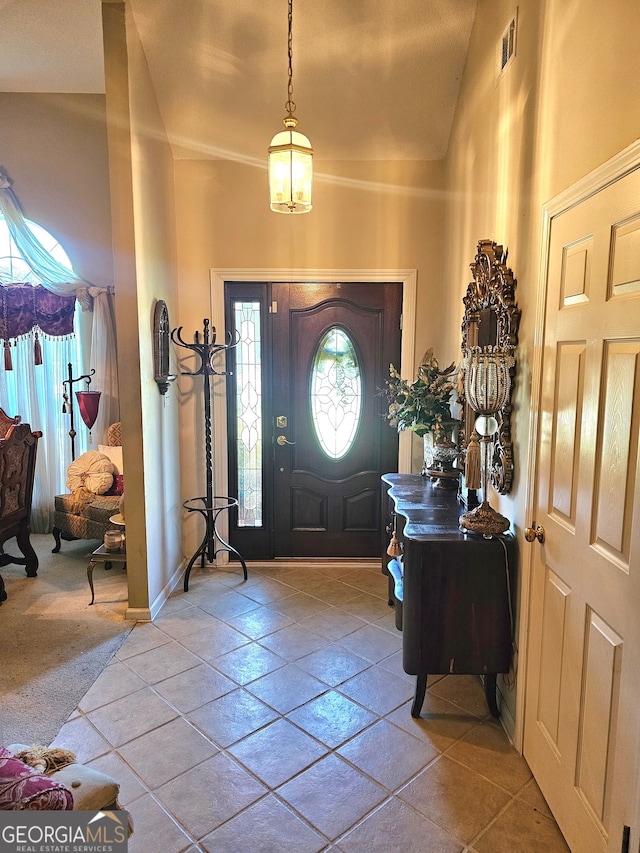 entryway featuring lofted ceiling