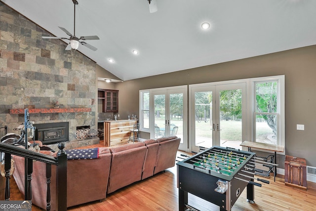 living room featuring high vaulted ceiling, light wood-type flooring, ceiling fan, and plenty of natural light