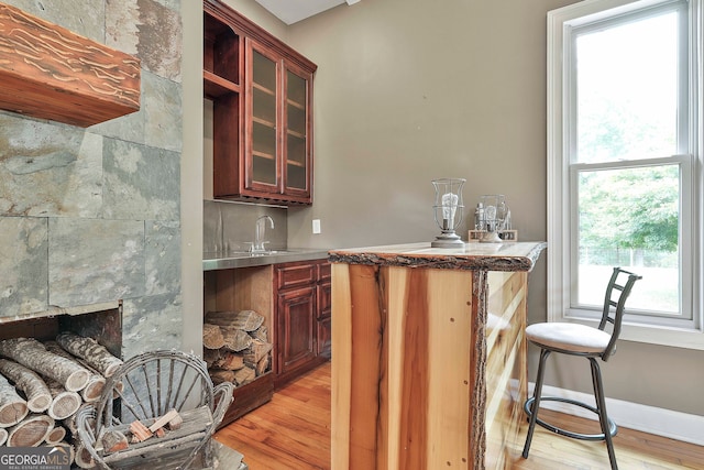 kitchen featuring light hardwood / wood-style flooring, sink, and stainless steel counters