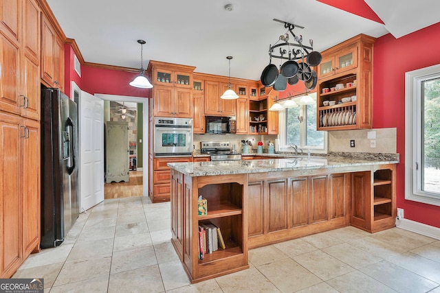 kitchen featuring black appliances, kitchen peninsula, tasteful backsplash, light stone countertops, and hanging light fixtures