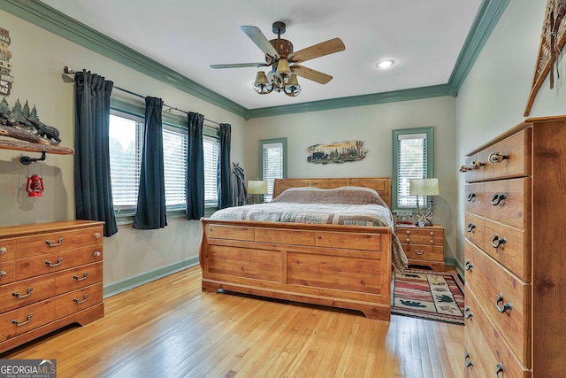 bedroom with ceiling fan, multiple windows, and light hardwood / wood-style flooring