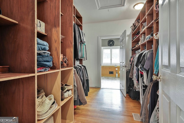 walk in closet featuring light hardwood / wood-style floors