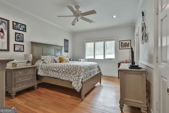 bedroom featuring crown molding, ceiling fan, and light hardwood / wood-style flooring