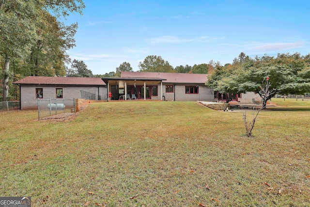 back of house featuring a yard