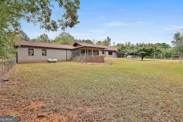 rear view of house with a yard