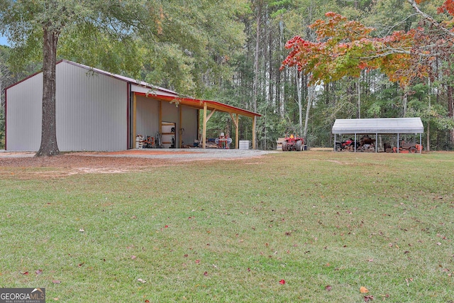 view of yard featuring an outdoor structure and a carport