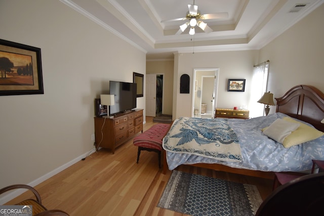 bedroom featuring light hardwood / wood-style flooring, ornamental molding, a raised ceiling, and ceiling fan