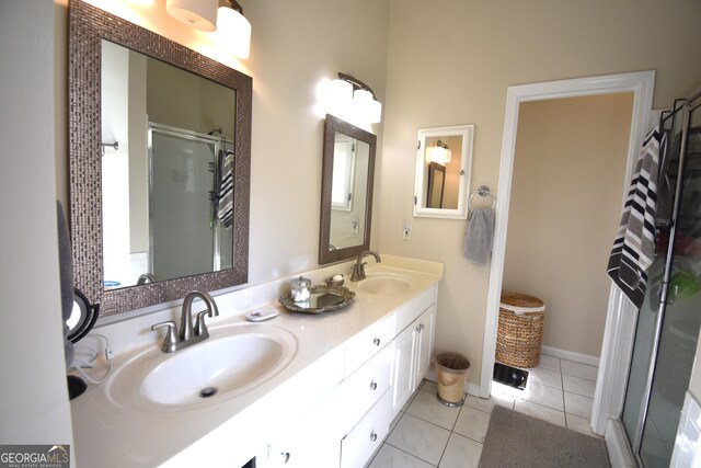 bathroom with vanity, a shower with shower door, and tile patterned flooring