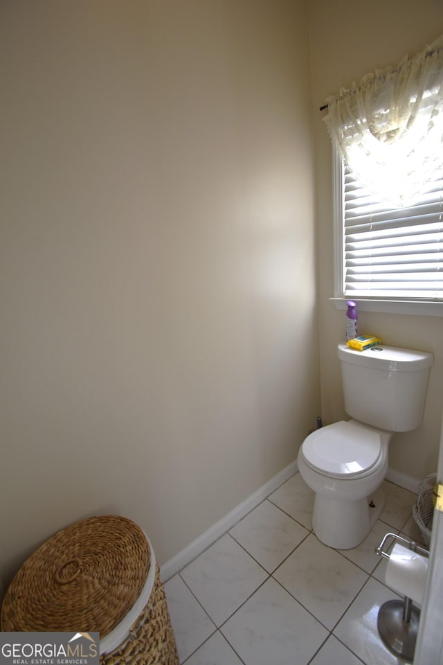 bathroom with tile patterned floors and toilet