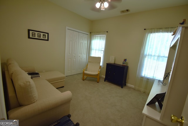 interior space with ceiling fan