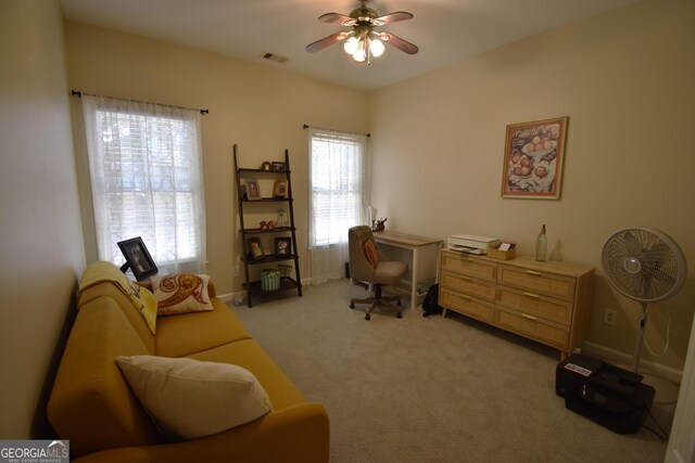 office space with light carpet and ceiling fan