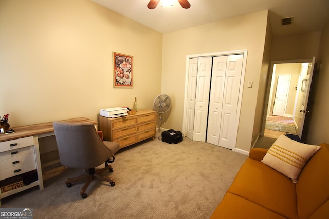 office space featuring ceiling fan and light colored carpet