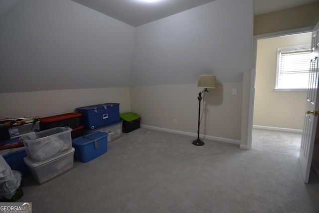 bonus room featuring lofted ceiling and light carpet