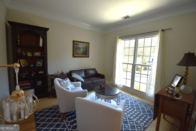 living room with crown molding and wood-type flooring