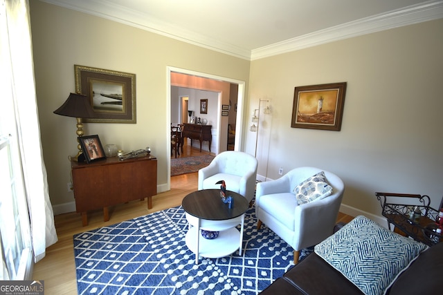 living area featuring crown molding and hardwood / wood-style flooring