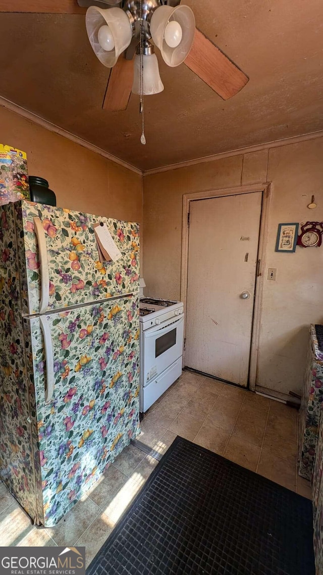 1870 Bethlea Ave, Macon, GA 31204 - kitchen featuring gas range gas stove, crown molding, light tile patterned floors, ceiling fan, and freestanding refrigerator