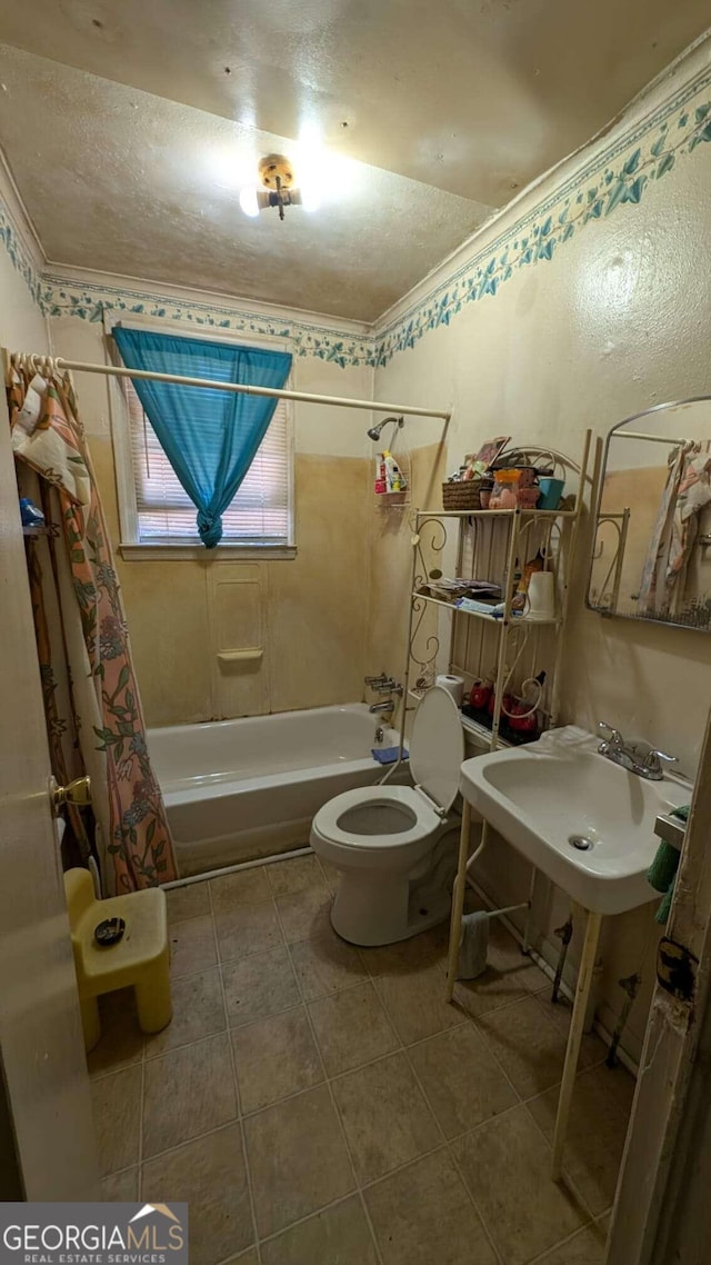 1870 Bethlea Ave, Macon, GA 31204 - full bathroom with shower / bath combo with shower curtain, toilet, ornamental molding, a sink, and tile patterned flooring