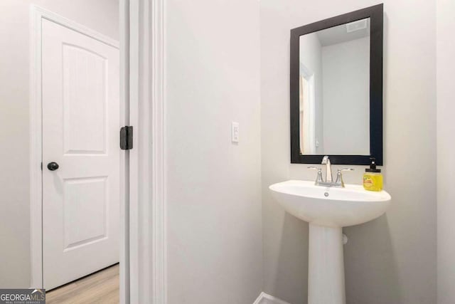 bathroom with hardwood / wood-style floors and sink