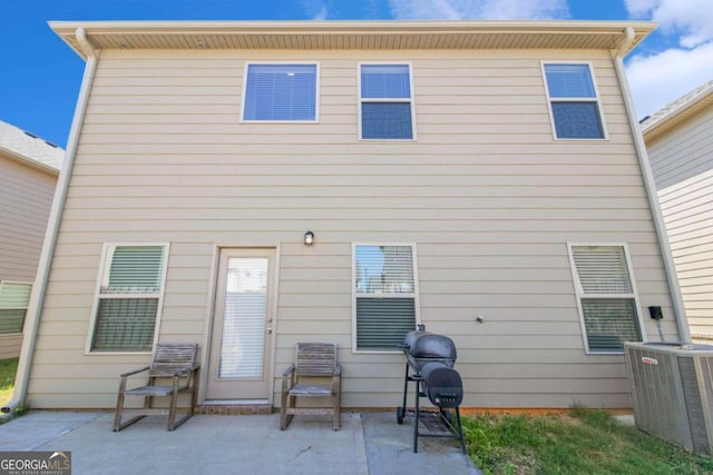 back of house featuring central AC unit and a patio area