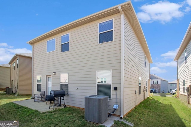 back of property featuring a patio area, central AC, and a lawn