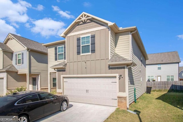 view of front of house with a front yard and a garage