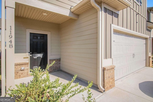 doorway to property with a garage