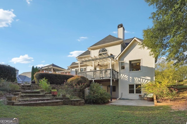 back of property featuring a pergola, a patio area, and a lawn