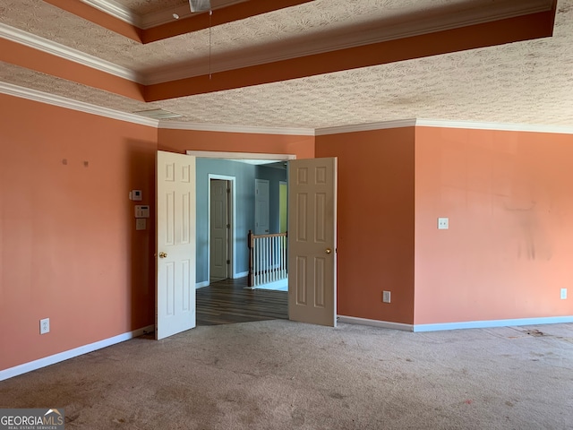 empty room featuring ornamental molding, a textured ceiling, and carpet flooring