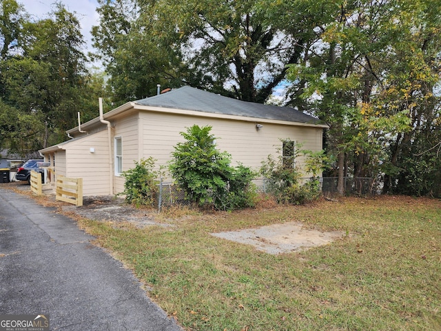 view of side of property with a yard