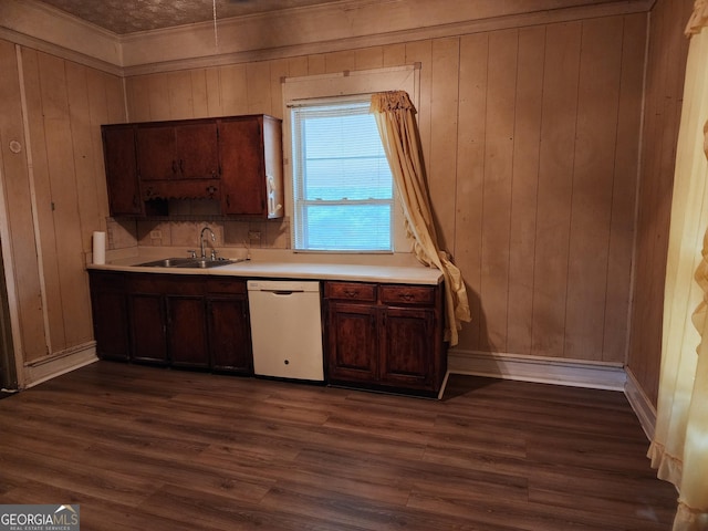 kitchen with dishwasher, dark hardwood / wood-style floors, wooden walls, and sink