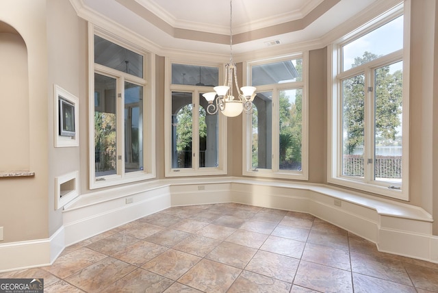 unfurnished dining area featuring crown molding, a chandelier, a raised ceiling, and arched walkways