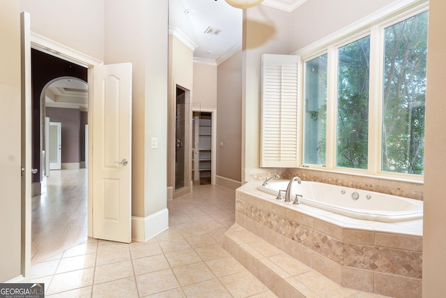 full bath with ornamental molding, a bath, tile patterned floors, and baseboards