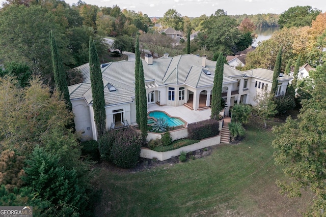 aerial view of property and surrounding area featuring a pool